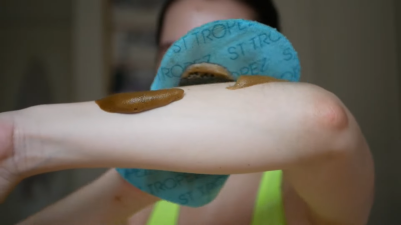 A Woman Applying Self-Tanner