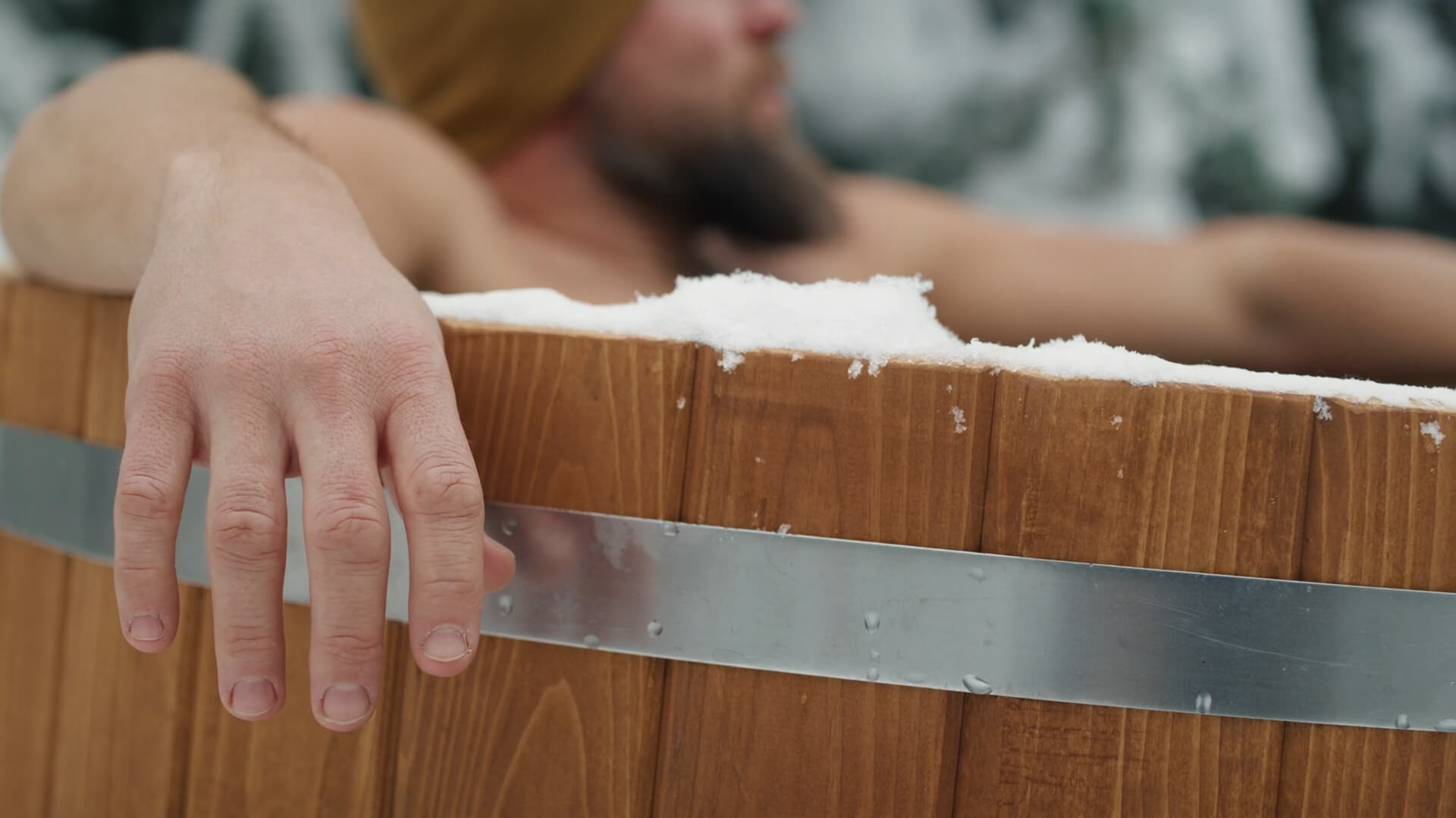 A man in a hot tub during winter